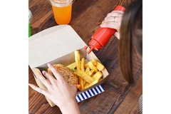 Women eating food from fast food packaging.